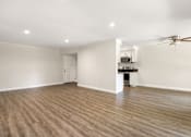 Thumbnail 21 of 69 - a living room and kitchen with wood flooring and a ceiling fan at Lombardi Apartments, California, 91367