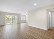 Thumbnail 50 of 69 - A spacious room with wooden flooring and white walls.