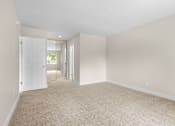 Thumbnail 55 of 69 - A room with a carpeted floor and white walls.