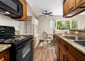Thumbnail 42 of 69 - a kitchen with a stove top oven and a sink at Lombardi Apartments, California, 91367