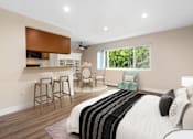 Thumbnail 40 of 69 - a bedroom with a bed and a living room with a kitchen at Lombardi Apartments, Woodland Hills