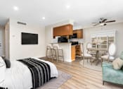 Thumbnail 41 of 69 - a bedroom with a bed and a kitchen with a table and chairs at Lombardi Apartments, Woodland Hills, CA, 91367
