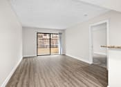 Thumbnail 43 of 54 - an empty living room with a patio door at Woodland Trio Apartments, North Hollywood, CA