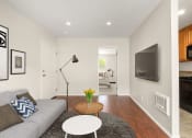 Thumbnail 1 of 41 - Apartments for Rent in West Hills, CA - Topanga - Living Room with Wood-Style Flooring, TV, and Couch.