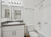 Thumbnail 8 of 55 - A white bathroom with a sink, toilet, and bathtub.