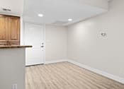Thumbnail 42 of 54 - a kitchen and dining room with white walls and wood floors at Woodland Trio Apartments, North Hollywood