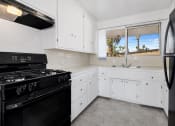 Thumbnail 11 of 23 - Kitchen with updated cabinets and all black appliances