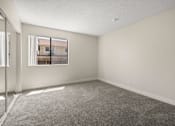 Thumbnail 4 of 40 - A room with a carpeted floor and a window.
