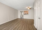 Thumbnail 1 of 40 - A room with a ceiling fan and wooden flooring.
