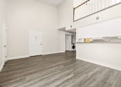 Thumbnail 10 of 40 - the living room and kitchen of a house with wood flooring