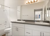 Thumbnail 14 of 40 - a bathroom with a sink and a toilet and a mirror
