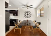 Thumbnail 2 of 36 - A black and white kitchen with a table and chairs.