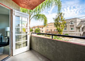 Thumbnail 5 of 54 - A balcony with a chair and a view of a residential area.