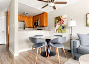 Thumbnail 1 of 54 - A modern kitchen with a dining table and chairs.