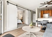 Thumbnail 7 of 54 - A modern living room with a sliding door and a ceiling fan.