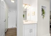 Thumbnail 11 of 60 - A bathroom with a white door and a white counter. at The Meadows at Westlake Village Apartments,Westlake Village, California