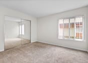 Thumbnail 37 of 60 - a bedroom with a large window and a mirror at The Meadows at The Meadows at Westlake Village Apartments,Westlake Village