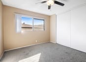 Thumbnail 18 of 23 - Carpeted bedroom with double closet doors.