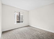 Thumbnail 44 of 54 - a bedroom with a large window at Woodland Trio Apartments, North Hollywood, California