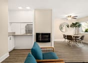 Thumbnail 3 of 60 - Living Room Featuring Fireplace & Ceiling Fan With Kitchen And Dining Area in Background at Casa De Marina Apartments, Los Angeles, CA