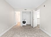 Thumbnail 45 of 54 - a bedroom with a washer and dryer at Woodland Trio Apartments, North Hollywood, CA