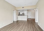 Thumbnail 11 of 55 - A kitchen area with white cabinets and appliances in a room with wooden flooring.