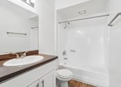 Thumbnail 16 of 55 - A white bathroom with a toilet, sink, and shower.