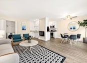 Thumbnail 1 of 60 - Living Room with Grey Couch, Circle Coffee Table, Matching Chairs, and Wood-Style Floors at Casa De Marina Apartments, California 90066