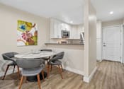 Thumbnail 1 of 55 - A kitchen with a dining table and chairs.