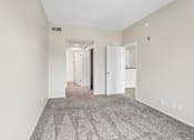 Thumbnail 19 of 55 - A hallway with a carpeted floor and white walls.