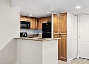 Thumbnail 41 of 54 - a kitchen with a counter top and a refrigerator at Woodland Trio Apartments, North Hollywood, CA