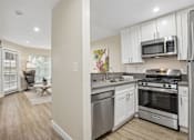 Thumbnail 3 of 55 - A kitchen with stainless steel appliances and wooden floors.