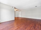 Thumbnail 24 of 47 - Apartments for Rent in Sherman Oaks, CA - Kystral Terrace - Living Room with Open Layout, Wood-Style Floors, and White Walls