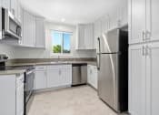 Thumbnail 14 of 47 - Apartments for Rent in Sherman Oaks - Krystal Terrace - Kitchen with Stainless-Steel Appliances, Natural Lighting, and White Cabinets