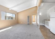 Thumbnail 2 of 15 - Carpeted Living Room at St. Andrews Apartments in Los Angeles