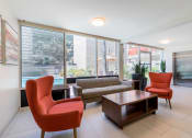 Thumbnail 29 of 47 - Sherman Oaks Apartments - Krystal Terrace Apartments Lobby with Table, Cozy Seating, and Modern Decor