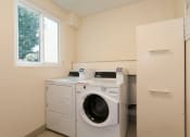 Thumbnail 41 of 47 - Apartments in Sherman Oaks for Rent- Laundry Room at Krystal Terrace Featuring Washer and Dryer