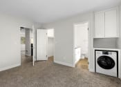 Thumbnail 18 of 41 - Two-Bedroom Apartments in West Hills, CA - Topanga Canyon - Interior View of Bedroom with Plush Carpeting, Washer/Dryer, and In-Suite Bathroom