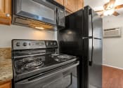 Thumbnail 5 of 41 - a kitchen with a stove and a refrigerator