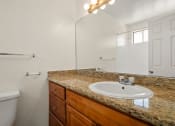 Thumbnail 9 of 41 - a bathroom with a sink and a toilet and a mirror