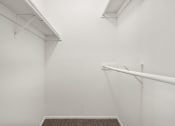 Thumbnail 8 of 41 - an empty white room with a white wall and a rail on the wall