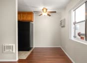Thumbnail 3 of 41 - an empty room with a ceiling fan and a refrigerator