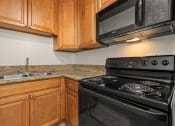 Thumbnail 4 of 41 - Apartments For Rent In West Hills, CA - Topanga Canyon - Kitchen With Upgraded Cabinets & Countertops And Black Appliances