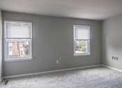 Thumbnail 27 of 37 - A room with two windows and carpeted floor.