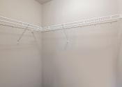 Thumbnail 7 of 24 - A white closet with a metal rod.