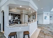 Thumbnail 23 of 25 - A kitchen with a bar area and a dining area at Abbey Ridge Apartment Homes, Oxford, MI, Michigan