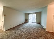 Thumbnail 28 of 33 - an empty living room with a door to a balcony