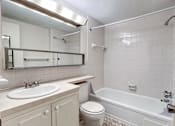 Thumbnail 31 of 33 - an empty bathroom with a sink toilet and bath tub