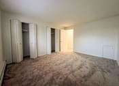 Thumbnail 33 of 33 - an empty living room with a carpeted floor and closet doors