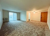 Thumbnail 26 of 33 - an empty living room with a window and a door